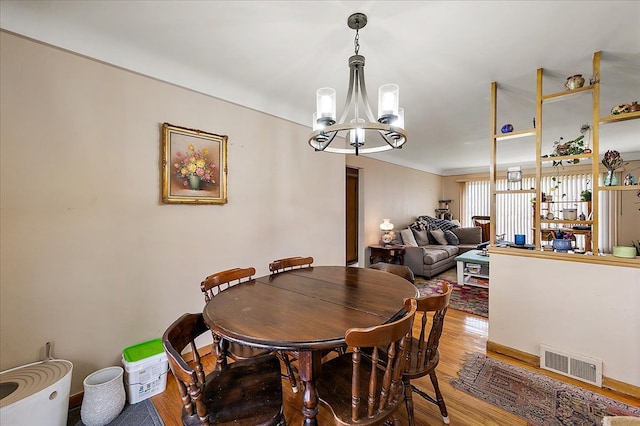 2180 Vernier Rd, Grosse Pointe Woods, MI 48236 - dining space featuring light wood finished floors, an inviting chandelier, and visible vents