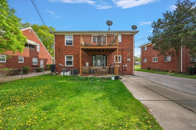 2180 Vernier Rd, Grosse Pointe Woods, MI 48236 - rear view of house featuring a balcony, a yard, brick siding, fence, and central AC