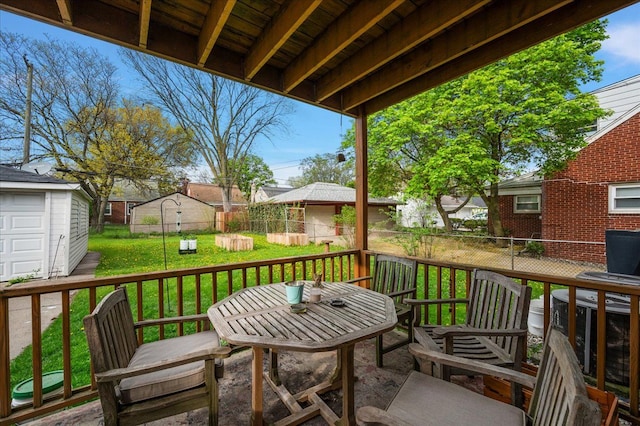 2180 Vernier Rd, Grosse Pointe Woods, MI 48236 - wooden terrace featuring a lawn, outdoor dining space, and fence