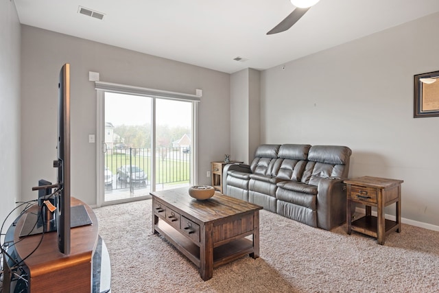 living area with visible vents and ceiling fan