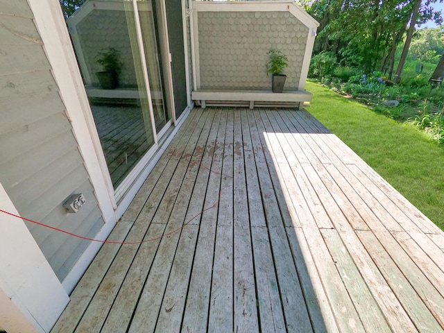 wooden deck with a lawn