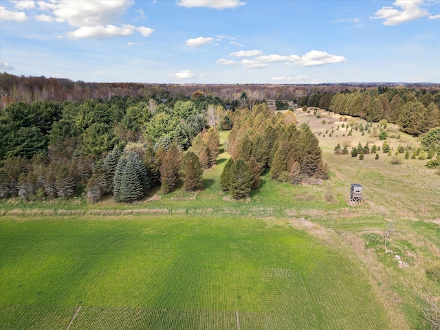 bird's eye view with a wooded view