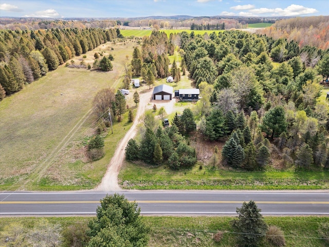 birds eye view of property with a view of trees