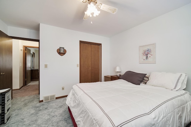 bedroom featuring a ceiling fan, visible vents, baseboards, a closet, and carpet flooring