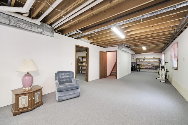basement with stairs and carpet flooring