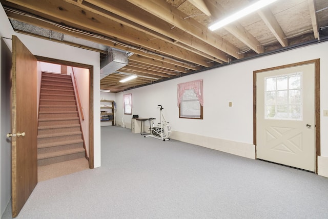basement with carpet flooring, plenty of natural light, and stairs