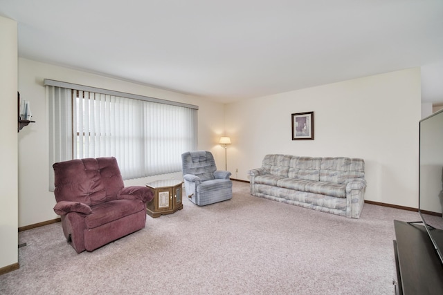 living room featuring carpet flooring and baseboards