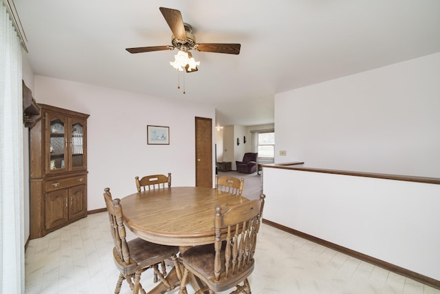 dining area featuring baseboards and a ceiling fan