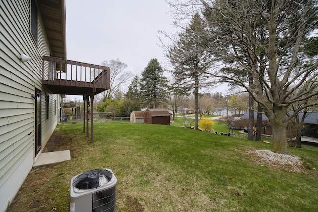view of yard with cooling unit, an outdoor structure, and a storage unit