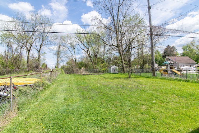 1291 E Lake Dr, Novi, MI 48377 - view of yard featuring a shed, an outbuilding, and a playground