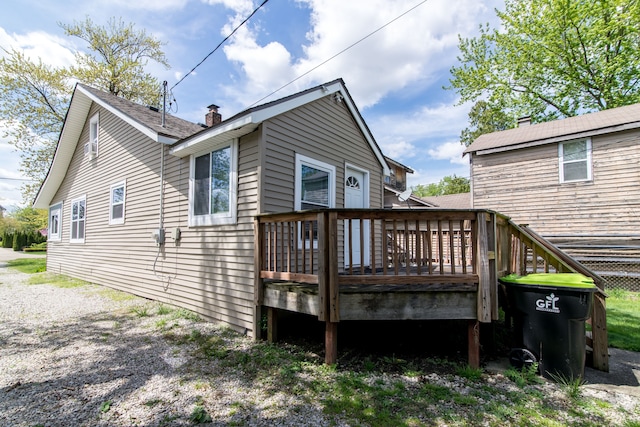 1291 E Lake Dr, Novi, MI 48377 - rear view of property with a wooden deck and a chimney
