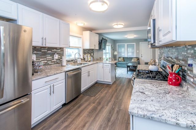 1291 E Lake Dr, Novi, MI 48377 - kitchen featuring stainless steel appliances, a sink, decorative backsplash, and white cabinets