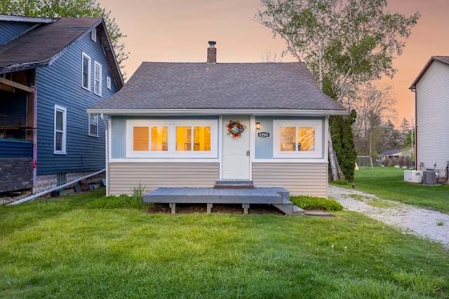 1291 E Lake Dr, Novi, MI 48377 - back of house featuring a chimney, central air condition unit, a yard, and roof with shingles