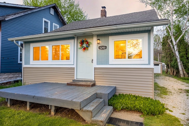 1291 E Lake Dr, Novi, MI 48377 - rear view of property with a chimney, roof with shingles, and a deck