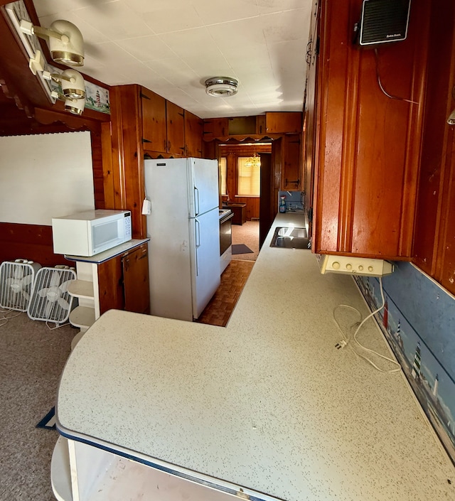 2964 Morin Point St, Erie, MI 48133 - kitchen with a sink, brown cabinetry, visible vents, white appliances, and light countertops