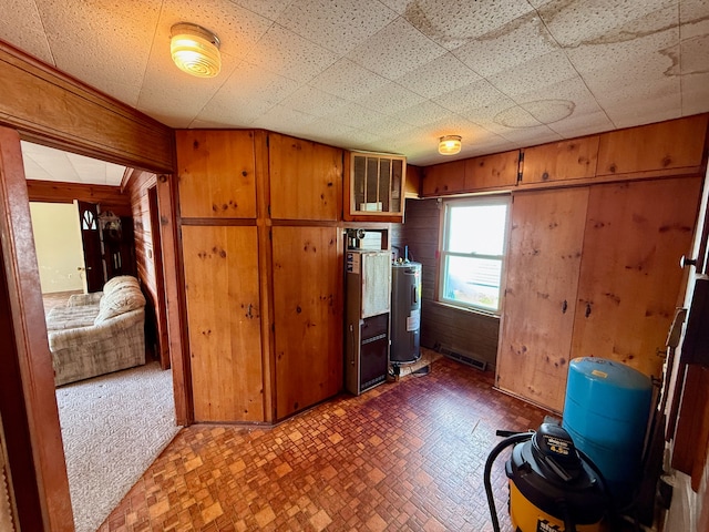2964 Morin Point St, Erie, MI 48133 - interior space featuring water heater, wood walls, brick patterned floor, and visible vents