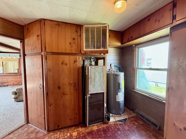 2964 Morin Point St, Erie, MI 48133 - laundry area with electric water heater, brick patterned floor, wood walls, and visible vents