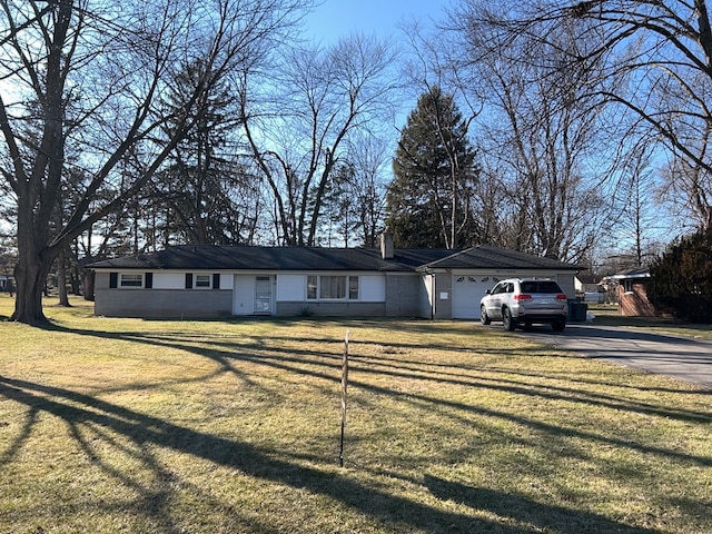 single story home with a garage, aphalt driveway, a front yard, and a chimney