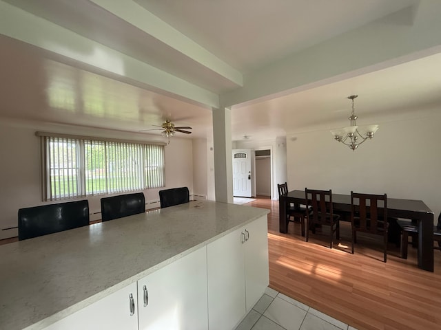 5781 Wright Dr, Troy, MI 48098 - kitchen featuring a chandelier, hanging light fixtures, a baseboard heating unit, light tile patterned flooring, and light countertops