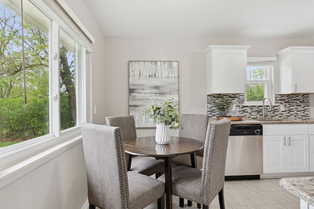 dining space featuring light tile patterned floors