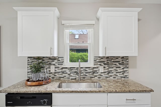 kitchen featuring a sink, white cabinetry, light stone countertops, backsplash, and dishwasher