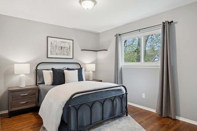 bedroom with baseboards and dark wood-style floors