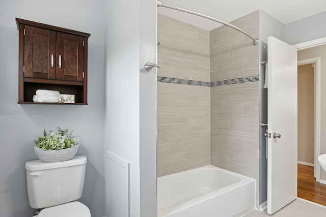 bathroom featuring toilet and shower / bathtub combination