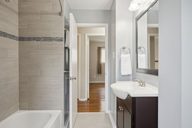 full bathroom with shower / bath combination, vanity, and baseboards