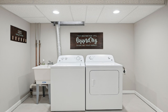 clothes washing area featuring independent washer and dryer, baseboards, and recessed lighting