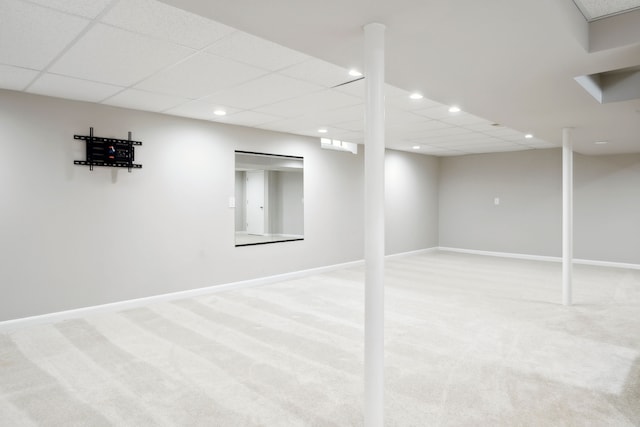 finished basement with light carpet, baseboards, recessed lighting, and a drop ceiling
