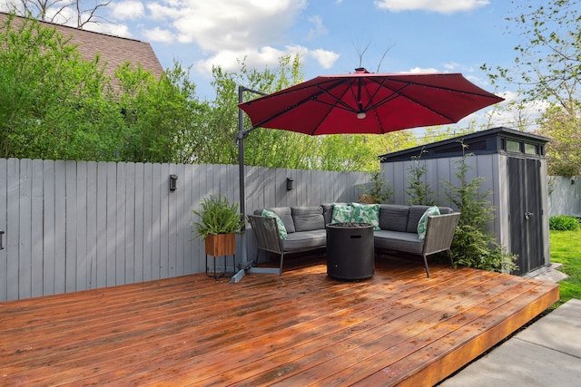 wooden terrace featuring an outdoor hangout area and a fenced backyard