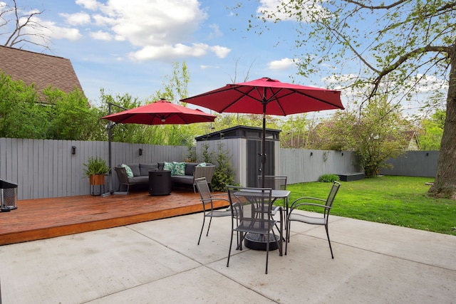 view of patio with outdoor dining area, a shed, an outdoor hangout area, a deck, and a fenced backyard