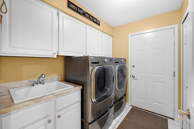 1095 Oregon Blvd, Waterford, MI 48327 - laundry room featuring light tile patterned floors, a sink, cabinet space, and washer and clothes dryer