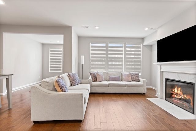 4867 Glenora Dr, Lake Orion, MI 48359 - living area featuring a fireplace, wood-type flooring, and baseboards