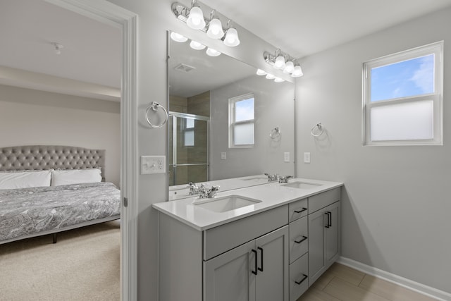 4867 Glenora Dr, Lake Orion, MI 48359 - bathroom with a shower stall, double vanity, baseboards, and ensuite bath