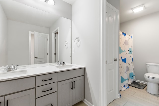 4867 Glenora Dr, Lake Orion, MI 48359 - full bath with toilet, double vanity, and baseboards