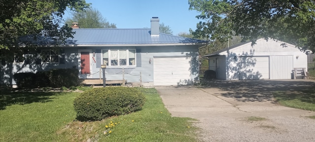 view of front of property featuring a chimney, concrete driveway, metal roof, a front lawn, and an attached garage