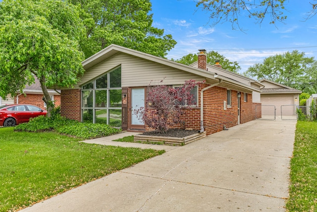 4938 Lincoln Blvd, Dearborn Heights, MI 48125 - mid-century modern home with a chimney, brick siding, a front lawn, a gate, and a garage