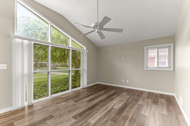 4938 Lincoln Blvd, Dearborn Heights, MI 48125 - unfurnished room featuring a textured ceiling, a ceiling fan, lofted ceiling, wood finished floors, and baseboards