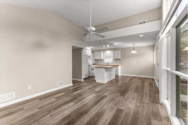 4938 Lincoln Blvd, Dearborn Heights, MI 48125 - unfurnished living room with dark wood-style flooring, baseboards, a ceiling fan, high vaulted ceiling, and a sink