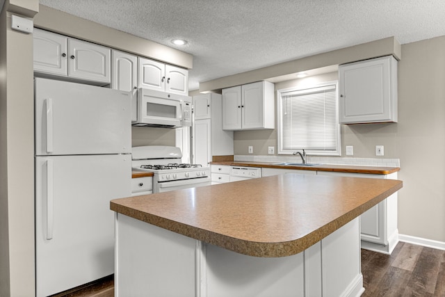 4938 Lincoln Blvd, Dearborn Heights, MI 48125 - kitchen featuring white appliances, a sink, dark wood-style flooring, a textured ceiling, and white cabinetry