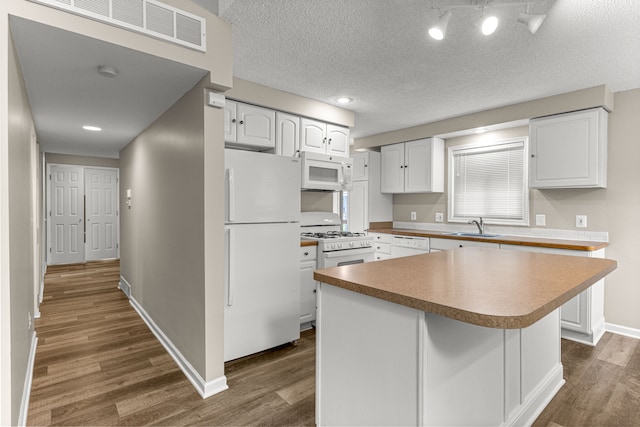 4938 Lincoln Blvd, Dearborn Heights, MI 48125 - kitchen with white appliances, dark wood-type flooring, baseboards, a sink, and white cabinetry