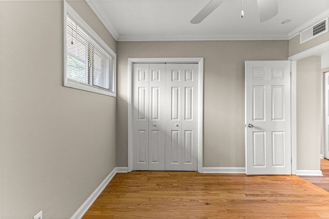 4938 Lincoln Blvd, Dearborn Heights, MI 48125 - unfurnished bedroom with light wood-style floors, crown molding, a closet, and baseboards