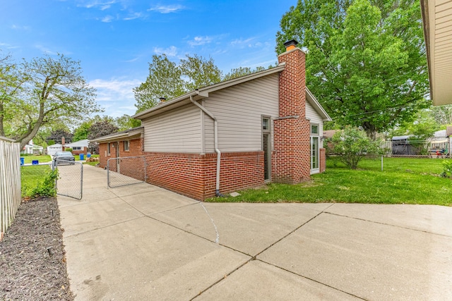 4938 Lincoln Blvd, Dearborn Heights, MI 48125 - view of home's exterior with a chimney and brick siding