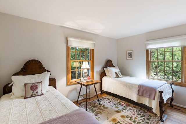 bedroom with baseboards and wood finished floors