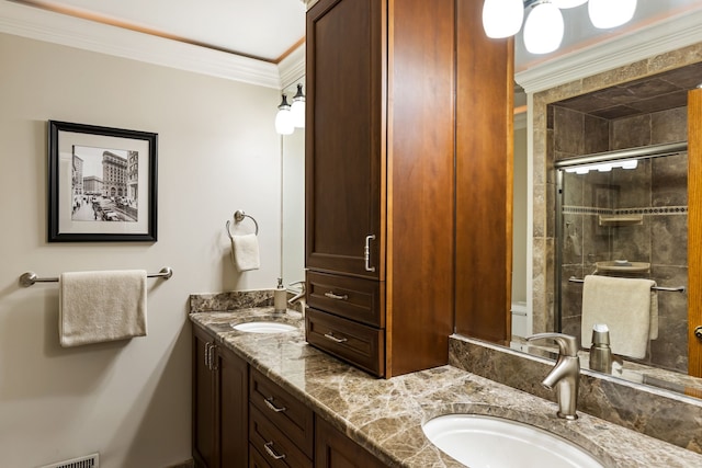 full bath with a stall shower, ornamental molding, double vanity, and a sink