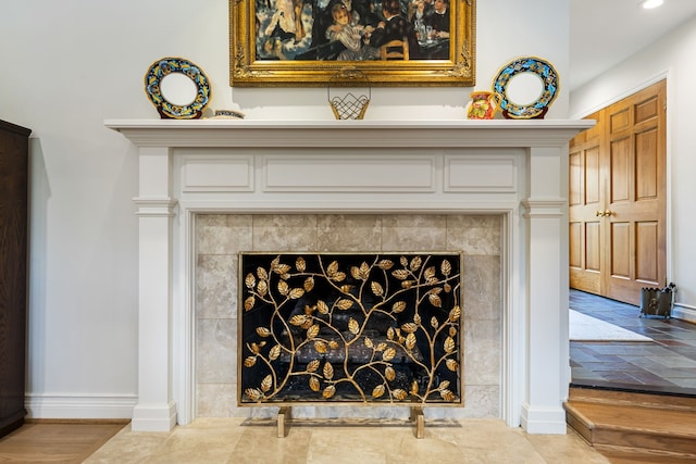 details featuring a fireplace, baseboards, and recessed lighting