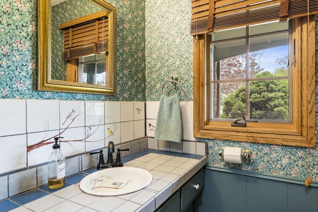 bathroom featuring vanity, a wainscoted wall, and wallpapered walls