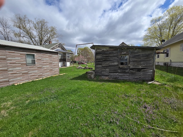1315 Mitchell St, Jackson, MI 49203 - view of yard with a storage shed, fence, and an outbuilding