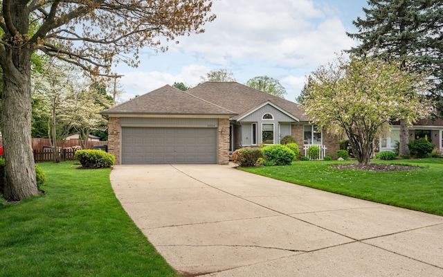 single story home with a front lawn, fence, brick siding, concrete driveway, and an attached garage